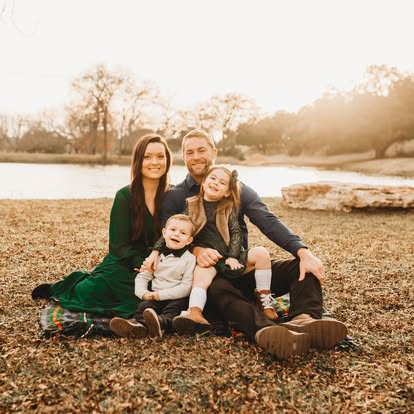 Sarah with her husband and children outdoors at sunset